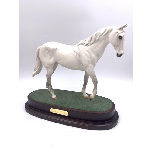 332 - A Royal Doulton Desert Orchid figurine on wooden plinth - approx. 23cm high