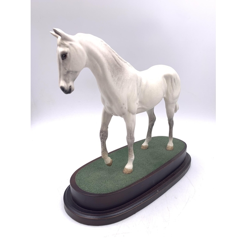 332 - A Royal Doulton Desert Orchid figurine on wooden plinth - approx. 23cm high