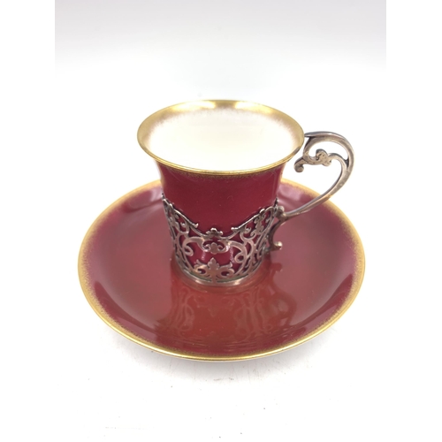 344 - Three Aynsley red and gold glazed cups and saucers with hallmarked London silver holders - approx. g... 