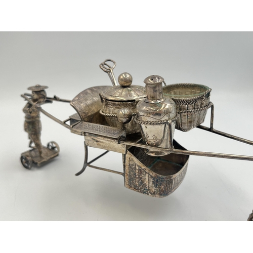 2204 - A vintage boxed Chinese 0.900 silver cruet set stamped WK, with porters carrying sedan chair and bas... 