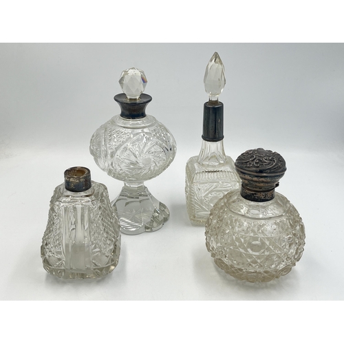 2210 - Four antique hallmarked silver and cut glass perfume bottles to include Birmingham 1908, Chester 190... 