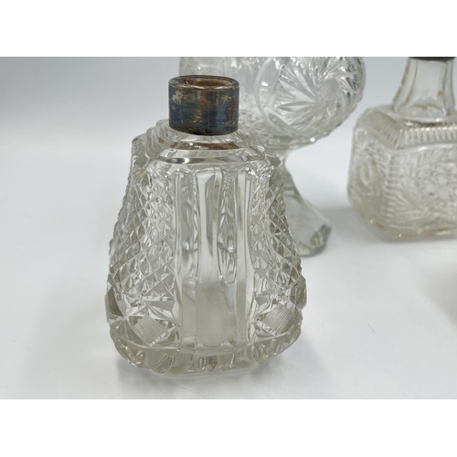 2210 - Four antique hallmarked silver and cut glass perfume bottles to include Birmingham 1908, Chester 190... 