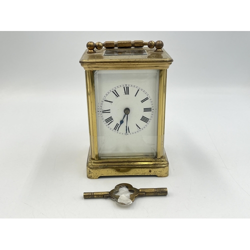 2220 - A late 19th/early 20th century brass chiming carriage clock with white enamel face and original key ... 