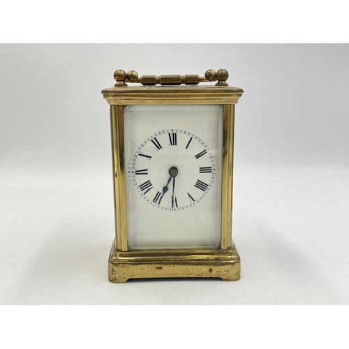 2220 - A late 19th/early 20th century brass chiming carriage clock with white enamel face and original key ... 