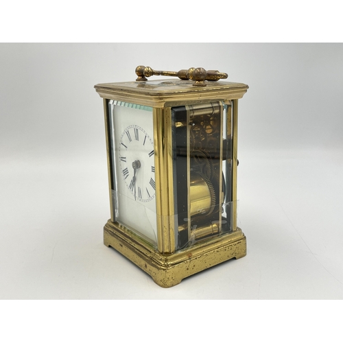 2220 - A late 19th/early 20th century brass chiming carriage clock with white enamel face and original key ... 