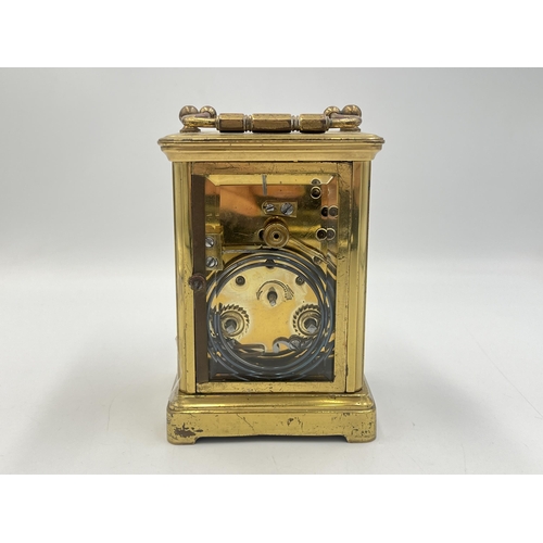 2220 - A late 19th/early 20th century brass chiming carriage clock with white enamel face and original key ... 