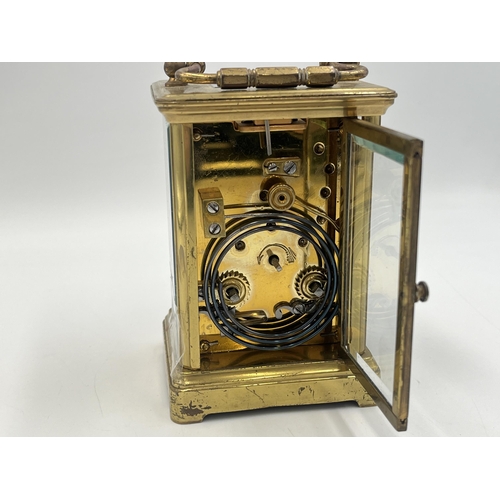 2220 - A late 19th/early 20th century brass chiming carriage clock with white enamel face and original key ... 