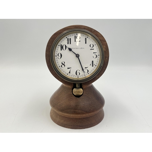 2221 - A 1930s Finnigan's Goliath 8 day pocket watch with Swiss movement and turned teak stand