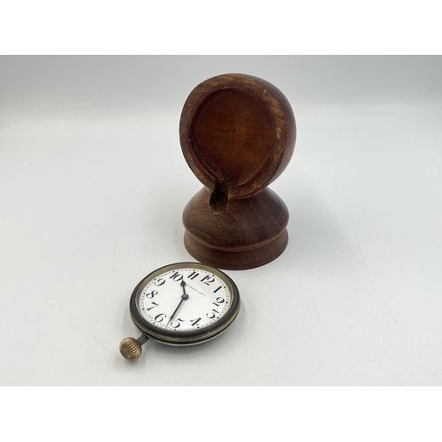 2221 - A 1930s Finnigan's Goliath 8 day pocket watch with Swiss movement and turned teak stand