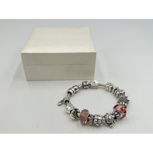 2257 - A boxed Pandora .925 silver charm bracelet with nineteen Pandora charms - approx. gross weight 67g