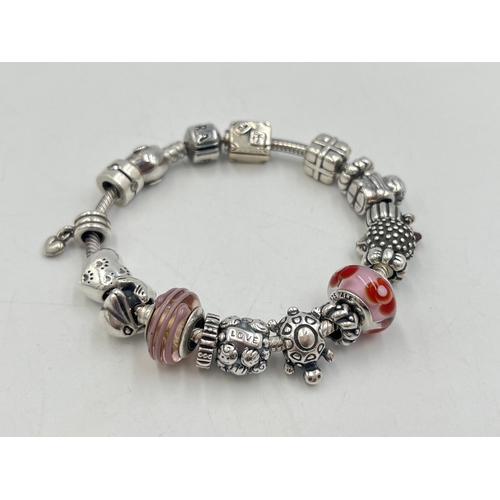 2257 - A boxed Pandora .925 silver charm bracelet with nineteen Pandora charms - approx. gross weight 67g