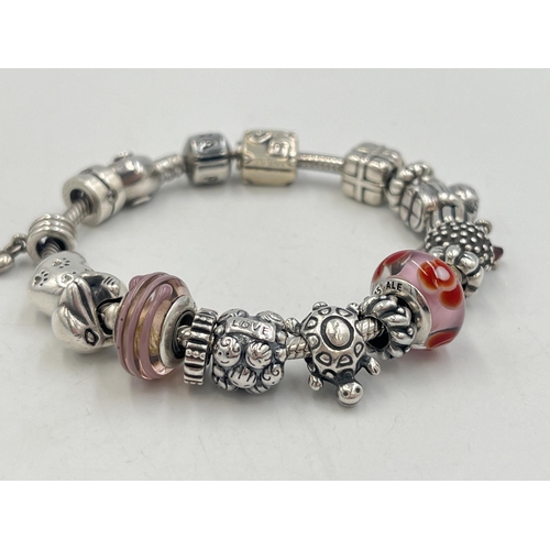 2257 - A boxed Pandora .925 silver charm bracelet with nineteen Pandora charms - approx. gross weight 67g