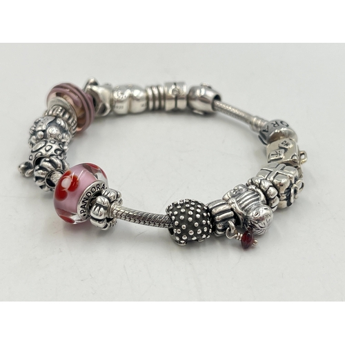 2257 - A boxed Pandora .925 silver charm bracelet with nineteen Pandora charms - approx. gross weight 67g