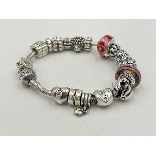 2257 - A boxed Pandora .925 silver charm bracelet with nineteen Pandora charms - approx. gross weight 67g