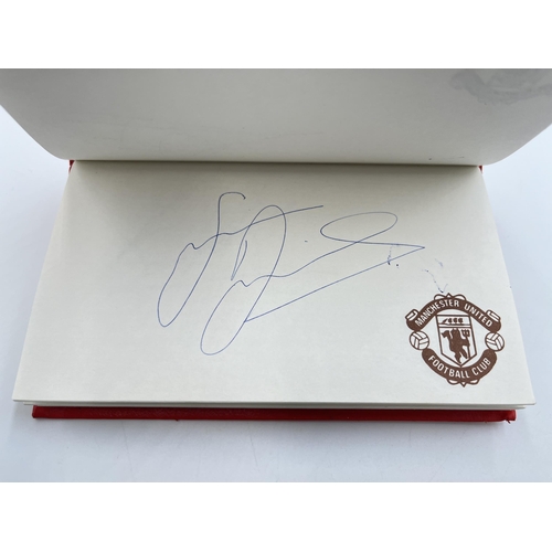 2297 - A Manchester United signed autograph book to include Alex Ferguson, Steve Bruce, Mark Hughes, David ... 