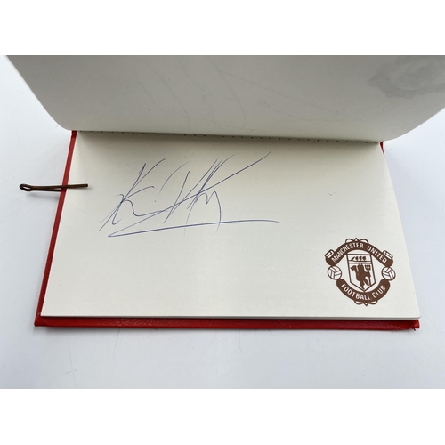 2297 - A Manchester United signed autograph book to include Alex Ferguson, Steve Bruce, Mark Hughes, David ... 