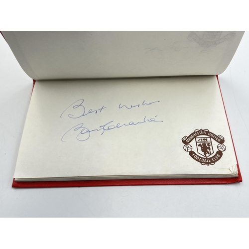 2297 - A Manchester United signed autograph book to include Alex Ferguson, Steve Bruce, Mark Hughes, David ... 