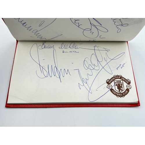 2297 - A Manchester United signed autograph book to include Alex Ferguson, Steve Bruce, Mark Hughes, David ... 