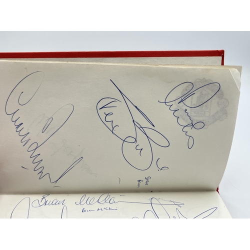 2297 - A Manchester United signed autograph book to include Alex Ferguson, Steve Bruce, Mark Hughes, David ... 