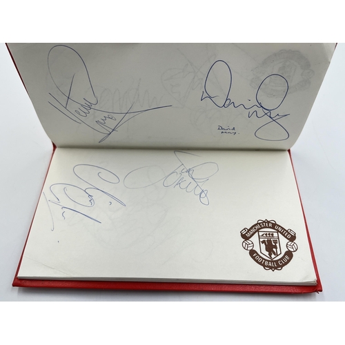 2297 - A Manchester United signed autograph book to include Alex Ferguson, Steve Bruce, Mark Hughes, David ... 