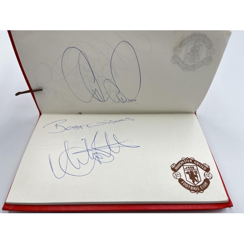 2297 - A Manchester United signed autograph book to include Alex Ferguson, Steve Bruce, Mark Hughes, David ... 