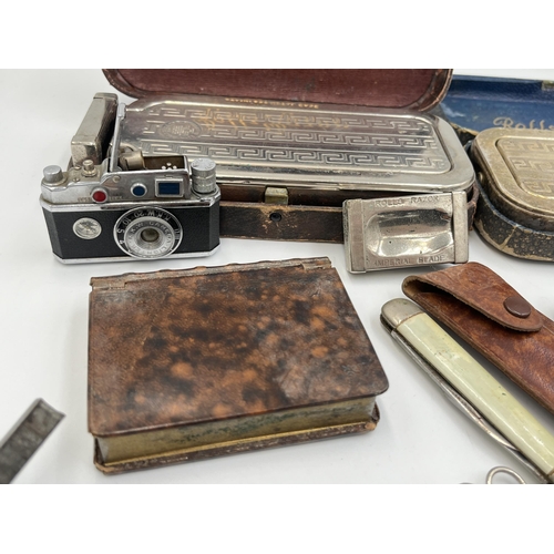 2298 - A collection of items to include mid 20th century Japanese K.K.W. Camera Lighter, Coldstream Guards ... 