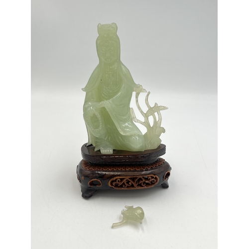 2308 - A hand carved jade Buddha figurine on hardwood stand - approx. 11cm high