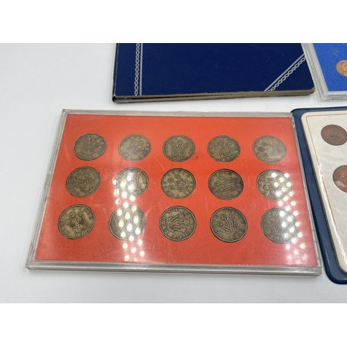 2323 - Four coin sets to include 'Britain's First Decimal Coins', Royal Mint 1977 etc. together with empty ... 