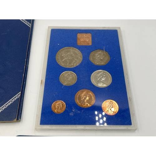 2323 - Four coin sets to include 'Britain's First Decimal Coins', Royal Mint 1977 etc. together with empty ... 