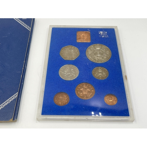 2323 - Four coin sets to include 'Britain's First Decimal Coins', Royal Mint 1977 etc. together with empty ... 