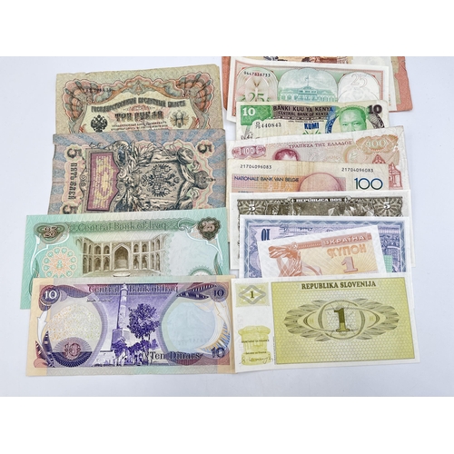 2328 - A collection of world banknotes to include Central Bank of Kenya, four Singapore $1, early 20th cent... 