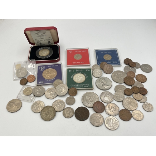 2329 - A collection of coins to include cased Sterling silver proof 1980 Isle of Man Christmas 50p, cased 1... 