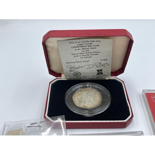 2329 - A collection of coins to include cased Sterling silver proof 1980 Isle of Man Christmas 50p, cased 1... 