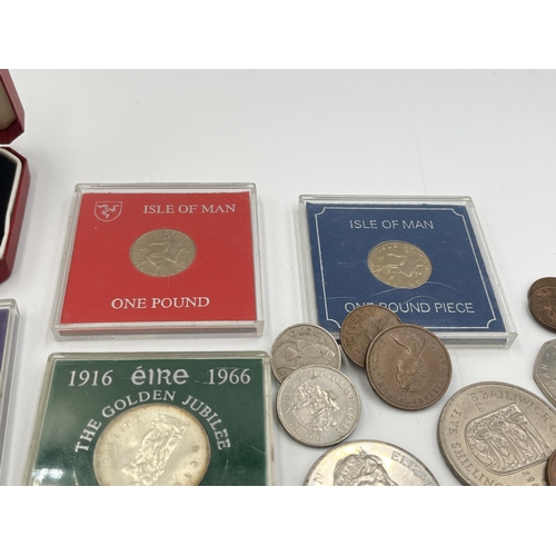 2329 - A collection of coins to include cased Sterling silver proof 1980 Isle of Man Christmas 50p, cased 1... 