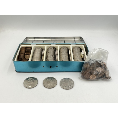 2345 - A 'Thrift Box' tin containing British decimal coins to include 2000, 2002 and 2003 £5 coins