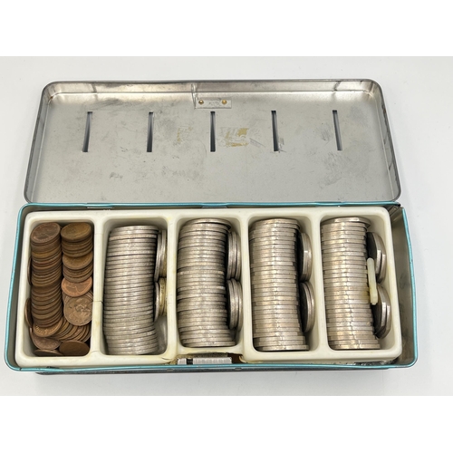 2345 - A 'Thrift Box' tin containing British decimal coins to include 2000, 2002 and 2003 £5 coins