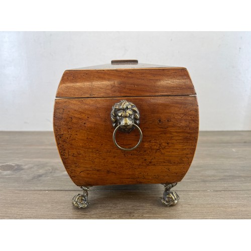 594 - A George III inlaid rosewood sarcophagus tea caddy with brass lion paw handles, mythical fish feet a... 