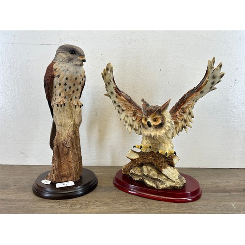 377 - Two resin bird figurines on wooden plinths, one Crosa Owl and one kestrel