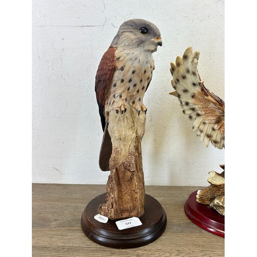 377 - Two resin bird figurines on wooden plinths, one Crosa Owl and one kestrel