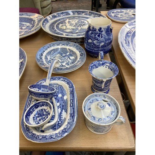 391 - A collection of 19th century and later Willow Pattern china to include WE stoneware meat plate, Maso... 