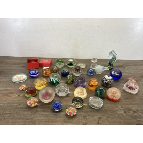 403 - A collection of art glass and Lucite paperweights to include Caithness, Mdina seahorse etc.