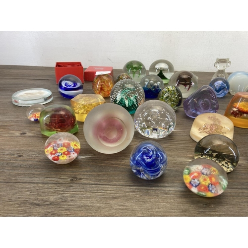 403 - A collection of art glass and Lucite paperweights to include Caithness, Mdina seahorse etc.