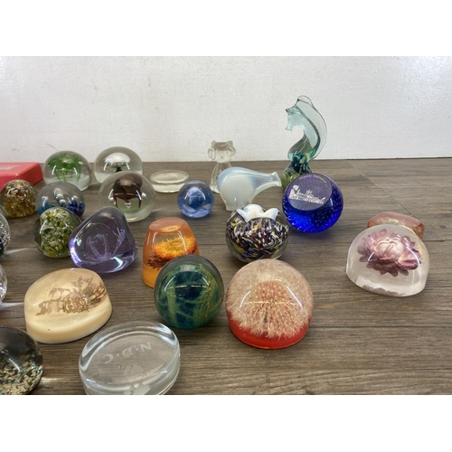 403 - A collection of art glass and Lucite paperweights to include Caithness, Mdina seahorse etc.