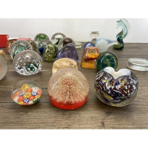 403 - A collection of art glass and Lucite paperweights to include Caithness, Mdina seahorse etc.