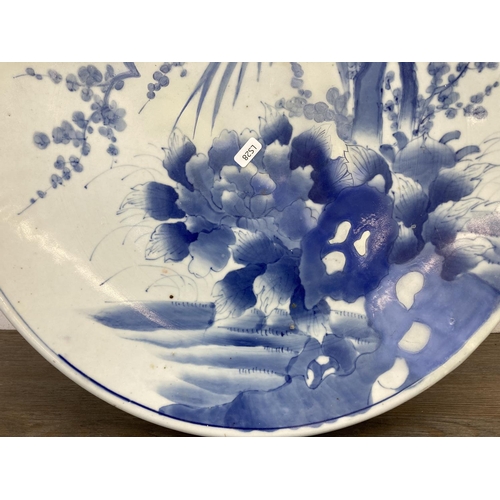 410 - A Japanese hand painted blue and white porcelain charger - approx. 46cm diameter