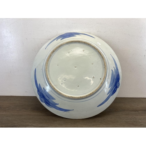 410 - A Japanese hand painted blue and white porcelain charger - approx. 46cm diameter