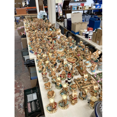 431 - An extensive collection of Pendelfin rabbit figurines and display stands to include Betsy Barge, Fat... 