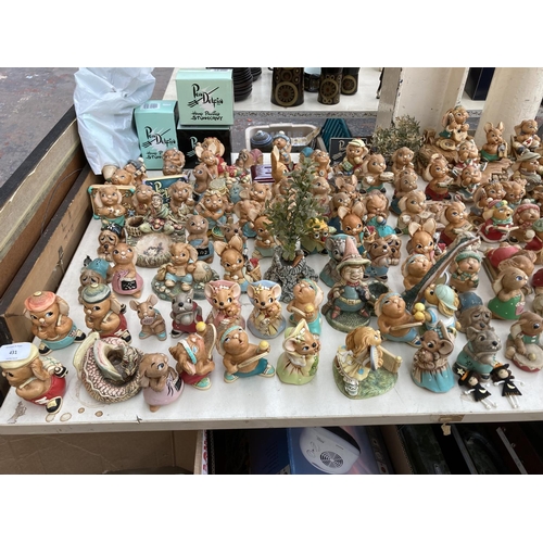 431 - An extensive collection of Pendelfin rabbit figurines and display stands to include Betsy Barge, Fat... 