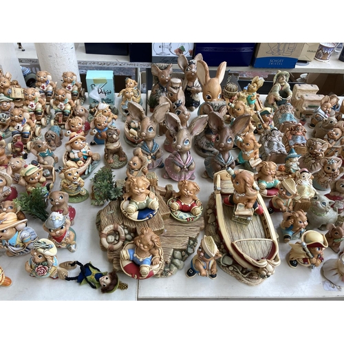 431 - An extensive collection of Pendelfin rabbit figurines and display stands to include Betsy Barge, Fat... 