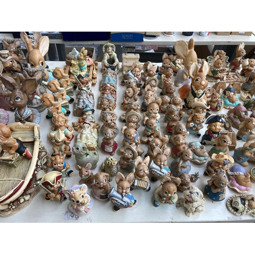 431 - An extensive collection of Pendelfin rabbit figurines and display stands to include Betsy Barge, Fat... 